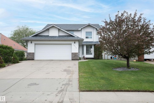 Two-story residence featuring white siding, a two-car garage, and a covered entry - 10739 109 Avenue, Westlock, AB 