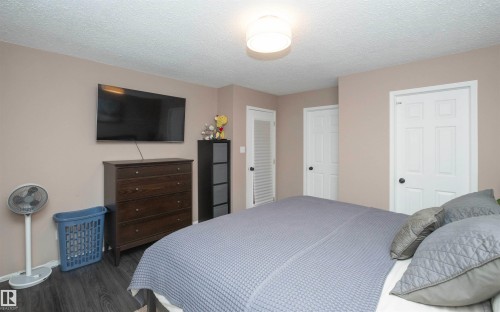 Room featuring neutral wall tones and dark wood-finish flooring - 10739 109 Avenue, Westlock, AB 