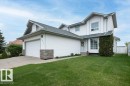Two-story residence featuring white siding and a prominent two-car garage with brick accents - 10739 109 Avenue, Westlock, AB 