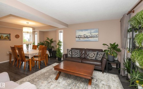 Open-concept living and dining areas featuring dark wood-finish flooring - 10739 109 Avenue, Westlock, AB 