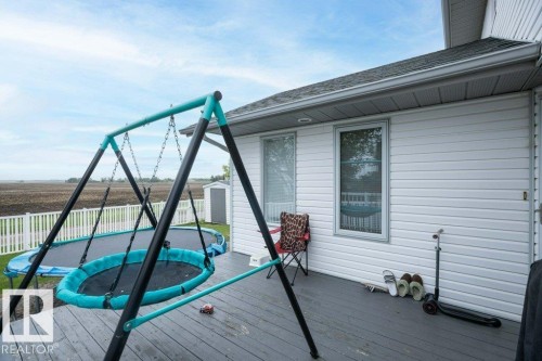 Rear deck featuring a gray wood-finish surface - 10739 109 Avenue, Westlock, AB 