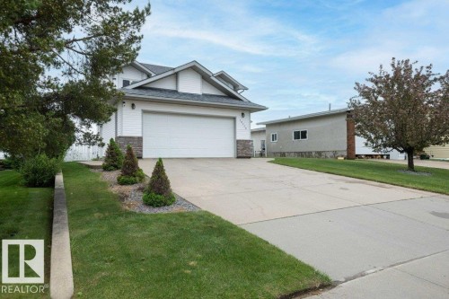 Two-story residence featuring white siding and a stone accent facade - 10739 109 Avenue, Westlock, AB 