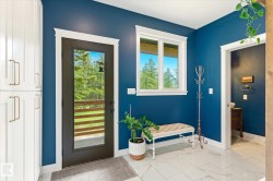 Entryway featuring a full-light exterior door, white trim, and a window providing natural light - 