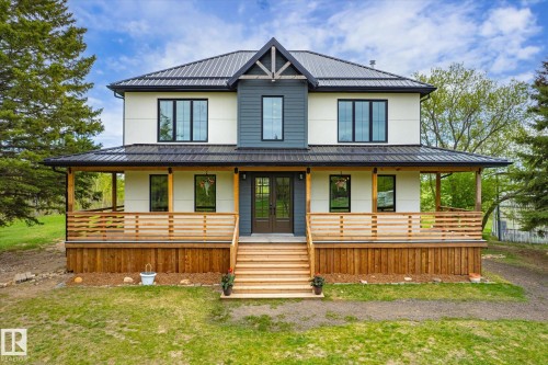 Contemporary two-story residence featuring a dark metal roof, white and charcoal siding, and black-framed windows - 59102 Rge Road 234, Rural Westlock County, AB 