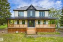 Contemporary two-story residence featuring a dark metal roof, white and charcoal siding, and black-framed windows - 59102 Rge Road 234, Rural Westlock County, AB 