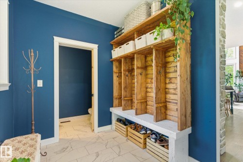Built-in rustic wood shelving unit with bench seating and individual storage cubbies - 59102 Rge Road 234, Rural Westlock County, AB 
