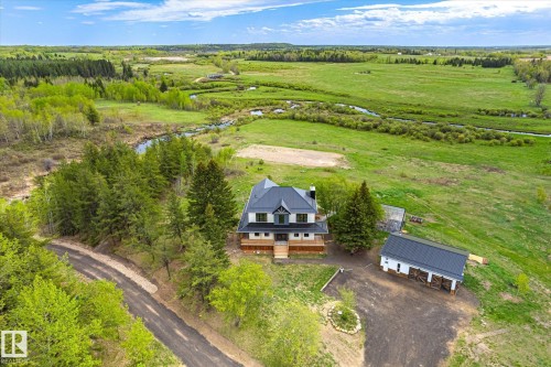 Two-story residence featuring a dark-pitched roof and light-toned siding, surrounded by extensive green landscape - 59102 Rge Road 234, Rural Westlock County, AB 