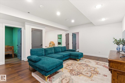 Spacious room featuring wood-finish flooring, recessed lighting, and multiple doorways with modern hardware - 59102 Rge Road 234, Rural Westlock County, AB 