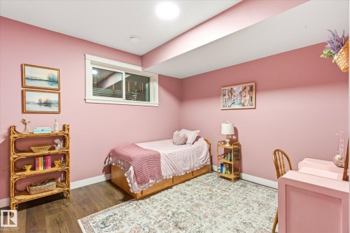 Spacious room featuring wood-finish flooring, a contemporary window with white trim, and recessed lighting - 59102 Rge Road 234, Rural Westlock County, AB 