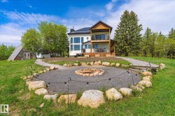 Outdoor fire pit area with gravel groundcover and natural stone surround - 