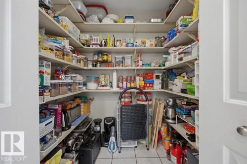 Huge walk-in pantry featuring white shelving, tile flooring, and double panel doors - 31 Wentworth Crescent, St. Albert, AB - Indoor With Storage