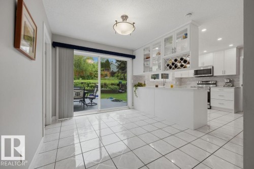 Your breakfast nook boasts a newer patio door to the huge 2-tier deck - 31 Wentworth Crescent, St. Albert, AB - Indoor Photo Showing Kitchen