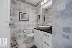 Renovated (2023) 2-pce main floor bath with marble top, a white vessel sink and ceramic tile flooring - 