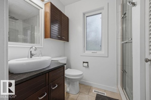 Renovated contemporary bathroom featuring marble tops, a vessel sink, double shower with tile surround - 31 Wentworth Crescent, St. Albert, AB - Indoor Photo Showing Bathroom