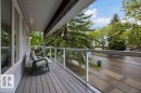 Large covered front porch featuring composite decking and glass panel railings - 31 Wentworth Crescent, St. Albert, AB  - Outdoor With Balcony With Deck Patio Veranda With Exterior 