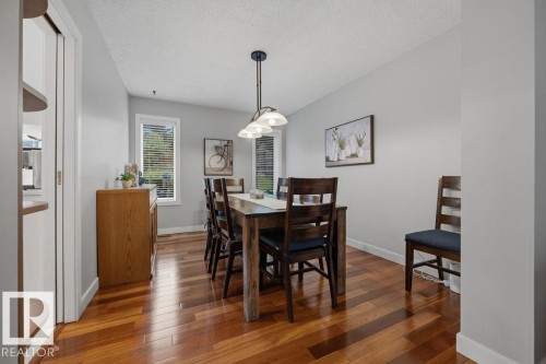 Dining area featuring Hardwood flooring and two windows with blinds - 31 Wentworth Crescent, St. Albert, AB - Indoor Photo Showing Dining Room