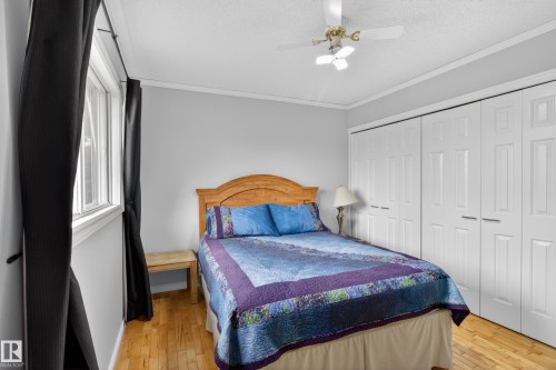 Hardwood-style flooring extends throughout this room, complemented by neutral wall tones and white trim - 110 52308 Rr 214, Rural Strathcona County, AB 