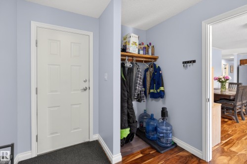 Entryway featuring a white panel door, light blue walls, and white baseboards - 110 52308 Rr 214, Rural Strathcona County, AB 