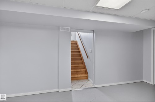 Finished basement space featuring light gray walls, white trim, and a drop ceiling with recessed lighting - 110 52308 Rr 214, Rural Strathcona County, AB 