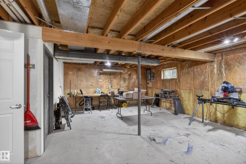 Unfinished basement space featuring exposed wood joists and structural beams - 110 52308 Rr 214, Rural Strathcona County, AB 