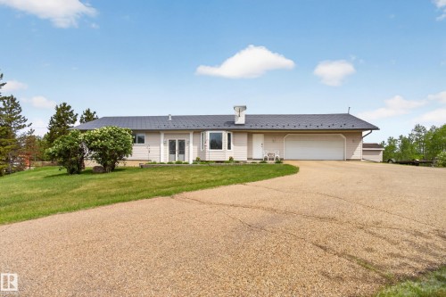Single-story residence featuring a dark-toned metal roof and light-toned siding - 110 52308 Rr 214, Rural Strathcona County, AB 