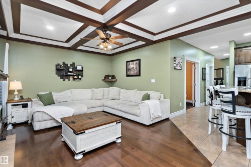 Living area featuring a coffered ceiling with recessed lighting and a ceiling fan - 16609 58A Street, Edmonton, AB 