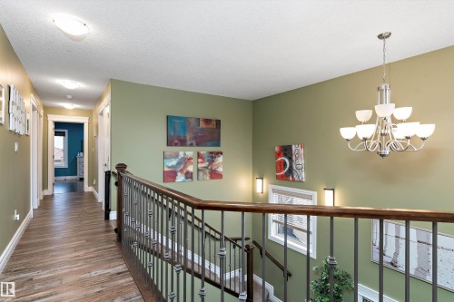 Upper-level hallway with wood-finish flooring - 16609 58A Street, Edmonton, AB 