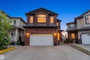 Brick facade residence with a prominent arched window, integrated two-car garage, and a concrete driveway - 16609 58A Street, Edmonton, AB 