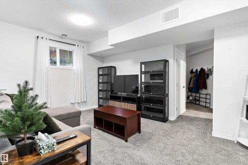 Finished interior space with light gray carpet flooring and white painted walls - 16609 58A Street, Edmonton, AB 
