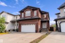 Brick-clad exterior with a prominent two-car garage - 16609 58A Street, Edmonton, AB 