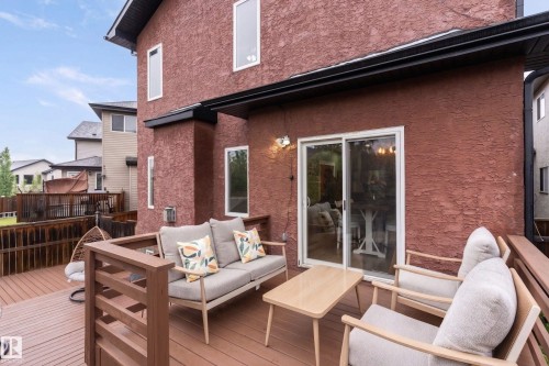 Expansive outdoor deck featuring wood-finish flooring and a slatted railing - 16609 58A Street, Edmonton, AB 