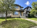 Two-story residence featuring light-colored siding with dark trim accents - 9432 211 Street, Edmonton, AB 