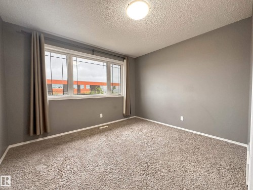 Spacious interior with neutral-toned walls and plush carpet flooring - 9432 211 Street, Edmonton, AB 