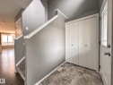 Entryway featuring gray-toned walls, decorative trim, and durable tile flooring - 9432 211 Street, Edmonton, AB 