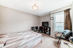 Carpeted room featuring a single window with brown curtains, a textured ceiling, and a flush-mount ceiling light fixture - 