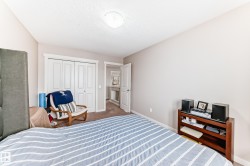 Carpeted room featuring a ceiling-mounted light fixture and light-toned walls - 