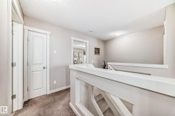 Upper landing featuring light gray painted walls and white trim - 