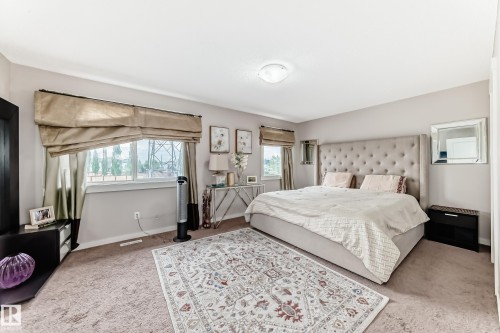 Plush carpet flooring provides comfort, complemented by a large window with natural light - 2808 36 Avenue, Edmonton, AB 