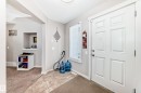 Entryway featuring a paneled door, tile flooring, and a large side window - 2808 36 Avenue, Edmonton, AB 