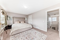 Carpeted room with neutral wall tones and a ceiling-mounted light fixture - 