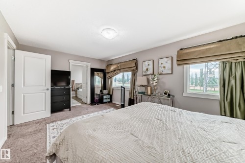 Carpeted bedroom featuring a neutral color palette and recessed lighting - 2808 36 Avenue, Edmonton, AB 