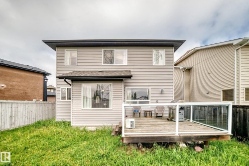 Rear exterior featuring light-toned horizontal siding and a dark shingled roof - 2808 36 Avenue, Edmonton, AB 