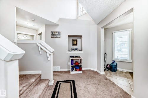 Split-level entry with carpeted stairs and white painted railings - 2808 36 Avenue, Edmonton, AB 