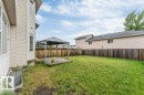Expansive backyard featuring a gazebo-covered wooden deck, a fully fenced perimeter, and a window well - 16315 55 Street, Edmonton, AB 