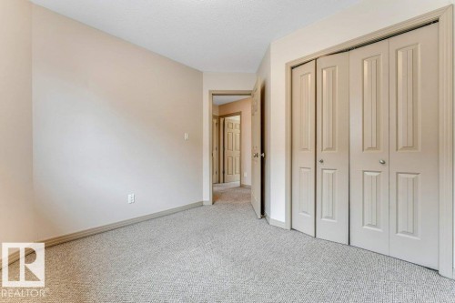 Neutral-toned walls complement the light-colored carpet, creating a bright atmosphere - 16315 55 Street, Edmonton, AB 