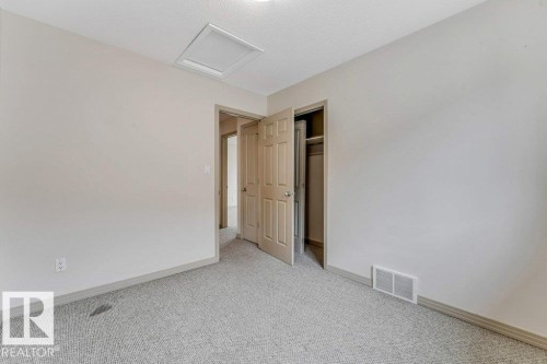 Neutral tone walls with light gray carpeting provide a versatile interior - 16315 55 Street, Edmonton, AB 