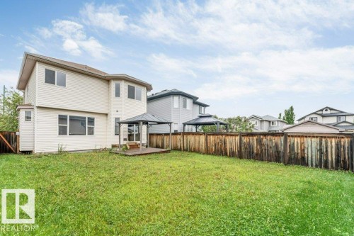 Expansive backyard with a large lawn area and wood privacy fencing - 16315 55 Street, Edmonton, AB 