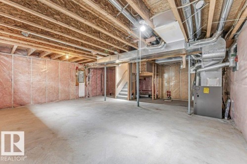 Expansive unfinished basement featuring concrete flooring and exposed ceiling joists - 16315 55 Street, Edmonton, AB 
