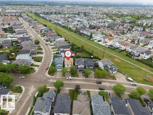 Aerial view of a residential neighborhood with numerous single-family homes, paved streets, and green spaces - 16315 55 Street, Edmonton, AB 