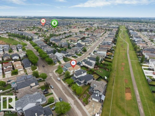 Aerial perspective of a residential neighborhood with detached homes, an extensive green space, and visible roadways - 16315 55 Street, Edmonton, AB 